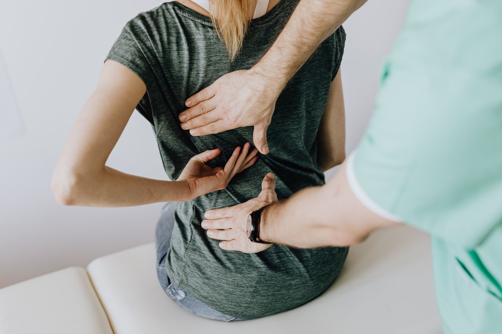 Chiropractor in Palm Harbor examining a patient's back for signs of misalignment