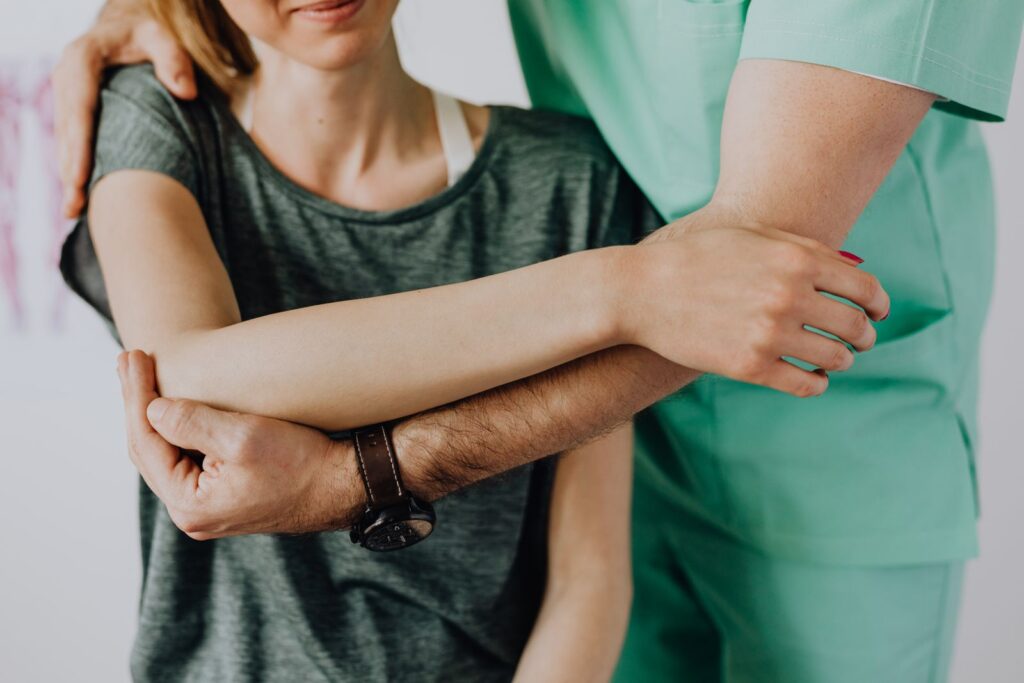Palm Harbor chiropractor examining a patient's shoulder during a first visit consultation